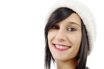 portrait of a pretty young brunette with winter hat, on white