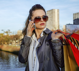 fashion-monger with shopping bags talking on smartphone in Paris