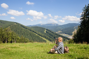 Fototapeta na wymiar Young traveler enjoying mountain view
