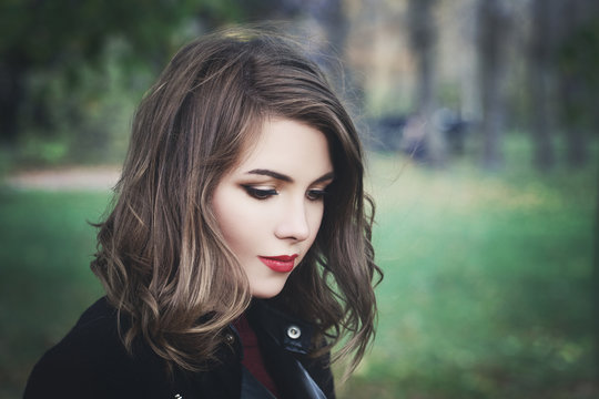 Lovely Girl In The Park. Pretty Woman With Long Bob Hair