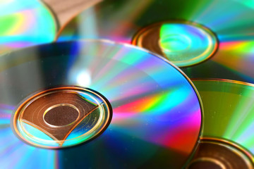 Many cd with reflections on a table. Suitable to be used like a background. Tilt-shift effect...