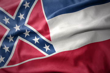 Naklejka premium waving colorful flag of mississippi state.