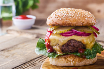 Burger with  gherkins, red onion and lettuce