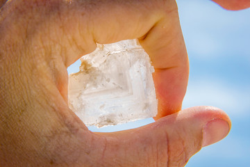 Holding big salt crystal in hand