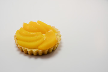 sliced peach tart isolated on white background