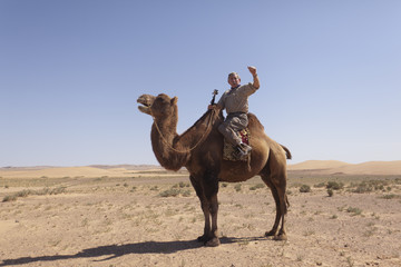 Westerner on a camel in the Gobi Desert in Mongolia
