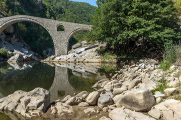 Fototapeta na wymiar Amazing Reflection of Devil's Bridge in Arda river and Rhodopes mountain, Kardzhali Region, Bulgaria
