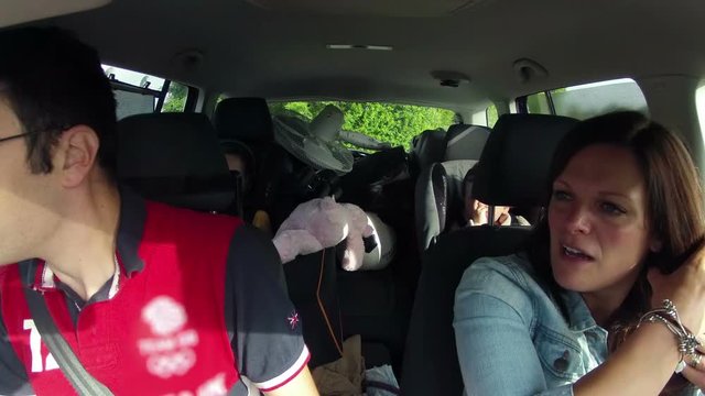 Young Family Going On Holiday With Car Full Of Belongings. Mum, Dad and Two Young Children Time Lapse As the Car Stops And Starts For Wee Wee Stops.