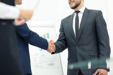 Diversity business team concluding contract with handshake in a 