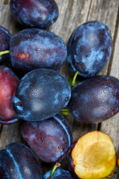 Fresh plums on a wooden table