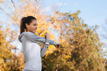 Young woman doing exercises in the park.