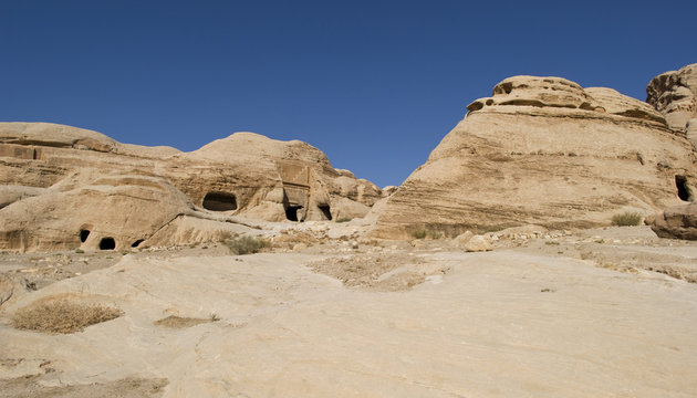 Rock cut tombs at the entrance to ancient Nabatean city of Petra, Jordan
