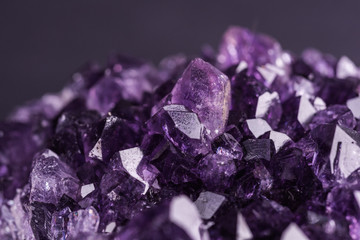 Amethyst geode on black background. Beautiful natural crystals gemstone. Extreme close up macro...