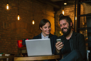 Businesspeople smiling coworking commenting and checking message