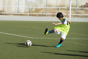 Niño en un entrenamiento de fútbol 7, deportes de equipo para actividades extraescolares