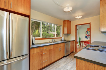 Narrow kitchen room with long grey counters