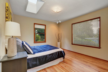 Simply furnished bedroom interior with hardwood floor