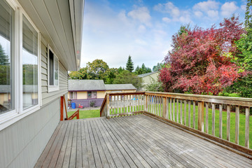 Empty Wooden walkout deck overlooking backyard garden