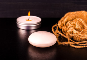 Soap,  candle and burlap on table.