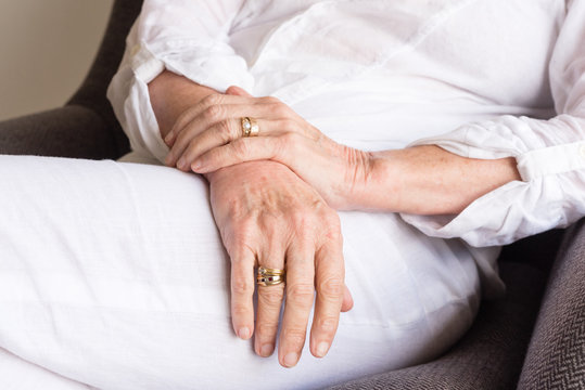 Close up of older woman's hands in relaxed position (cropped and selective focus)