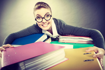 Happy crazy accountant with piles of binders.