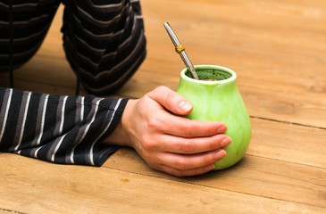 Unrecognizable woman drinking yerba mate