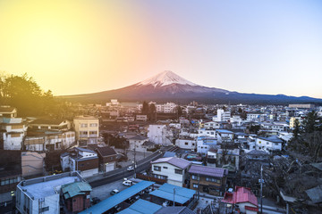 The small village in front of Fuji mountain in autumn morning. (With flare of warm sunlight effect)
