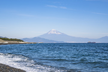 Stunning view of Fuji mountain from Miho no Matsubara Beach,Shizuoka,Japan, in soft blue sky with Haze and smoke effect at the mountain.