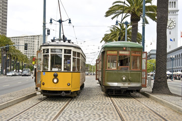 Vintage street cars in San Francisco headed in opposite directions.