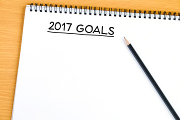 2017 goals on blank paper notebook background