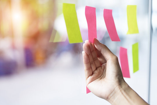 Business People Post It Note On Glass Wall In Office