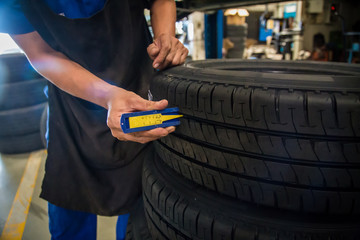 Car mechanic, Professional car mechanic changing car wheel in auto repair service.