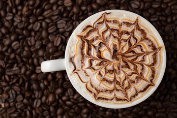 Cup of coffee on coffee beans background.