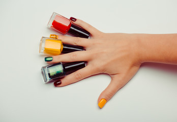 Multi-colored Nail Polish Bottles in the hands