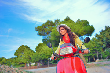 Attractive happy woman on a scooter