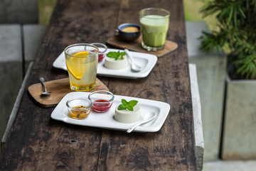Dessert panna cotta with fresh berries on wooden background, selective focus.Traditional Italian...
