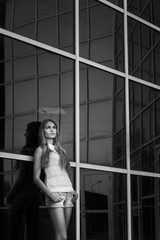 beautiful girl on background of the reflection in the window. black and white photo