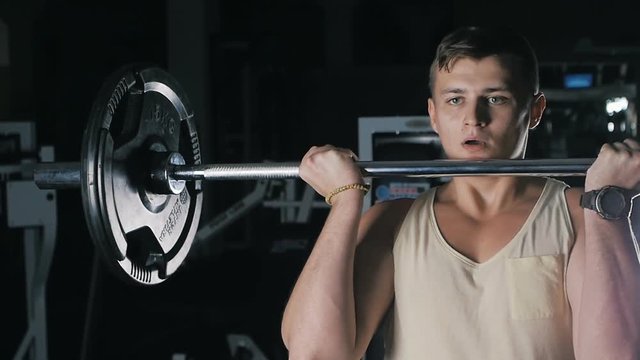 Side View Of Athlete Doing Barbell Curl