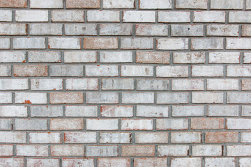 Grey brick wall with some pink bricks for background.