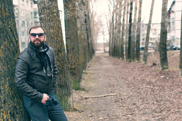 beard man in park with headphon
