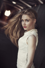 Fototapeta premium beautiful blonde girl stands in the tunnel