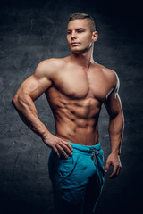 Fototapeta na wymiar Shirtless muscular male in contrast illumination.