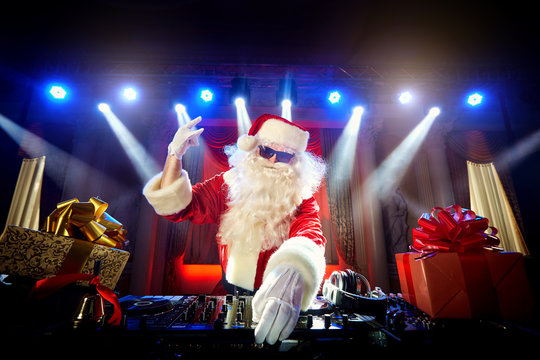 DJ Santa Claus mixing up some Christmas event.  Disco light arou