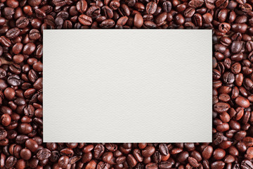 Paper on coffee beans background.