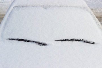 Fragment of car, covered with fluffy snow