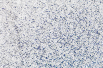 Background of a blue surface covered with fluffy snow