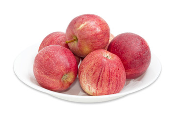 Several red apples on a white dish closeup