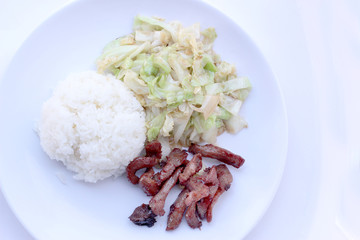 Fried cabbage with Shell oil on white dish and Fried Pork in white plate isolated on white backgeound, Thai food style
