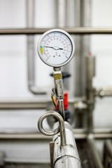 manometer on stainless pipe in milk production machine