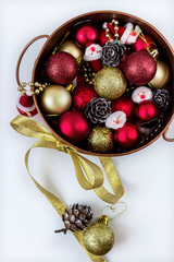 Beautiful gift box in gold wrapping paper with sharami and snowmen isolated on white background